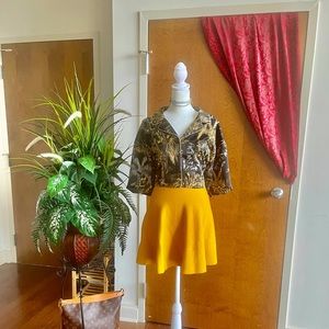 Short sleeve black and gold button down blouse.